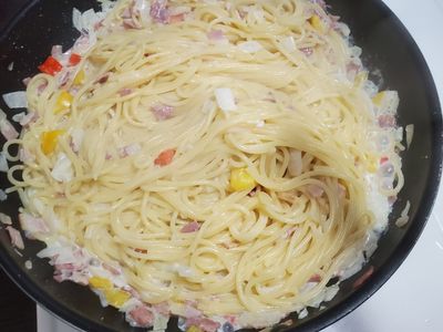 把麵加進去，加兩匙煮麵水。
讓麵吸一下湯汁，起鍋前把起司片切小塊加進去，熄火（起司片用餘溫融化）