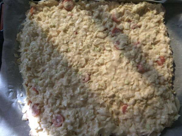 將所有的材料拌勻，在烤盤上舖上烘焙紙，將調好的糊倒入烤盤上，用刮刀舖平麵糊。