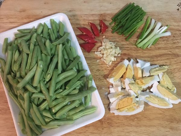 四季豆斜刀切；鹹蛋1顆切8片；辣椒斜切；蒜香切末；蔥切段。