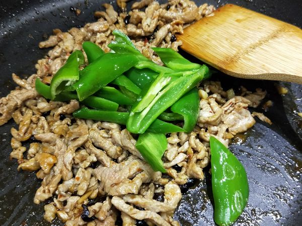 調味料與肉絲炒至收汁後，加入剛炒好的糯米椒拌炒。