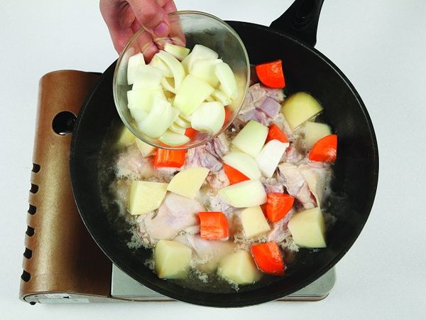 當雞肉開始煮熟變白時，放入馬鈴薯與紅蘿蔔、洋蔥。