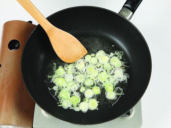 將食用油與大蔥放入平底鍋內，並以大火炒成蔥油。