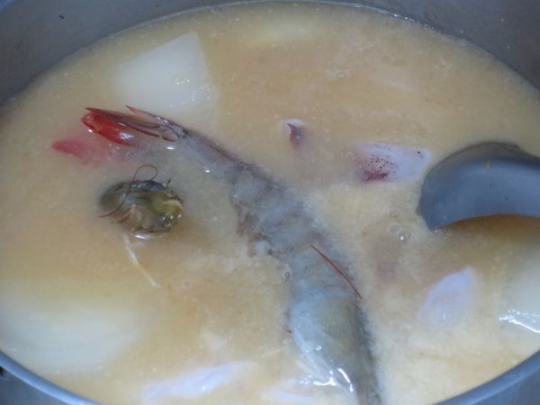 加入海鮮、加米酒。小滾煮海鮮，千萬別大火煮海鮮，大火煮肉質會變硬、變老。