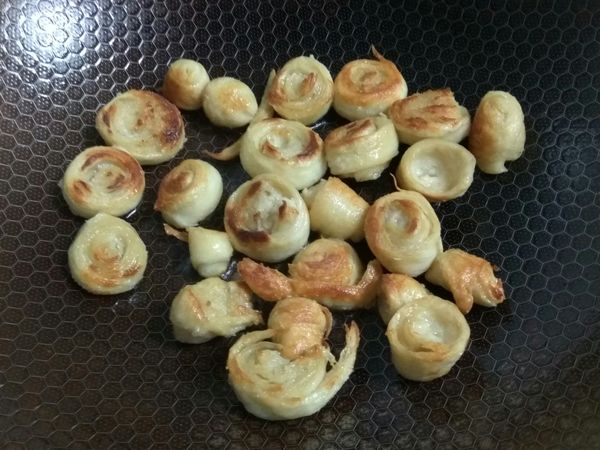 鍋內放入約兩大匙的油，將麵腸放入煸至表面焦黃後，起鍋備用