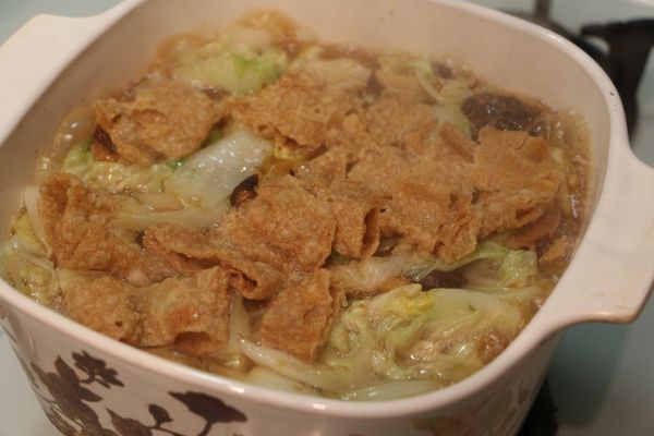 將豆皮鋪上於湯上，於湯內加入醬油、鹽、胡椒粉，煮滾後，轉中小火煮至白菜軟爛即可．