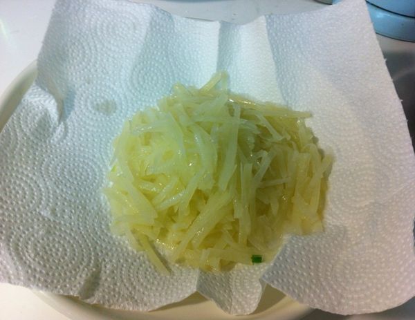 原本需要一段時間瀝乾水份的馬鈴薯絲，倒在鋪好廚紙的盤上，輕鬆將水份吸走。