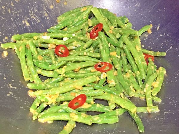 將作法2的四季豆放入炒至完全裹上鹹蛋黃，再加入少許鹹蛋白及辣椒拌炒即可。