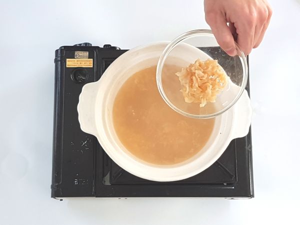 將白飯、干貝絲加進湯裡。
