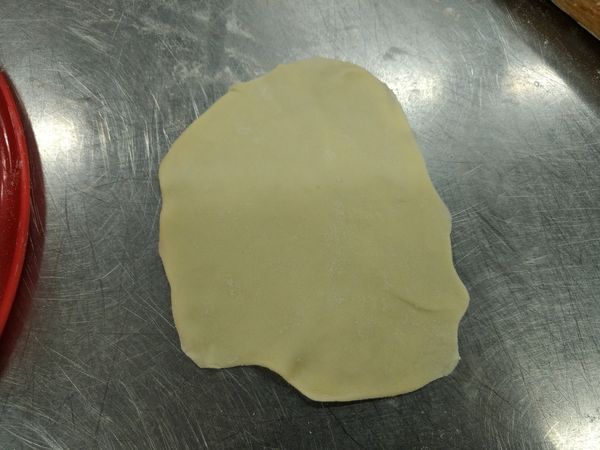 製作煎餃皮4：擀平，使面積大於模具。