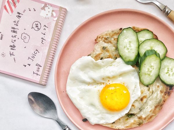 1.冷鍋冷油小火，放入冷凍蔥油餅，2-3分鐘翻面，適蔥油餅厚薄度分辨翻面時間
2小黃瓜🥒洗乾淨後擦乾，刨片1公分厚度，備用
3.蔥油餅正反面又冷凍煎至透明狀在變白色，約略各面煎5分鐘即可成盤
4.太陽蛋作法：平底鍋小火，倒入蛋白約2分鐘，再倒入蛋黃，等2分鐘，灑鹽即可起鍋