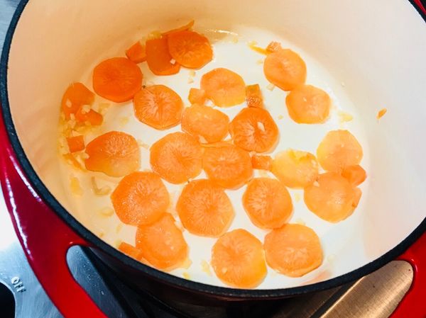 鍋中下油爆香蒜頭，放入大塊紅蘿蔔炒出紅蘿蔔素