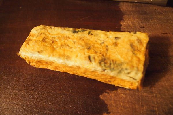 捲好的蛋推到鍋子的另一側，鍋內再薄薄倒入一層蛋液（蛋液要流到捲好的蛋底下），表面呈現半熟狀將蛋捲起。重覆這個動作至將蛋液全數用完，並將捲好的蛋捲持續放入鍋內，到表面呈現金黃色並帶有些微焦香。拿起放涼切成厚片備用