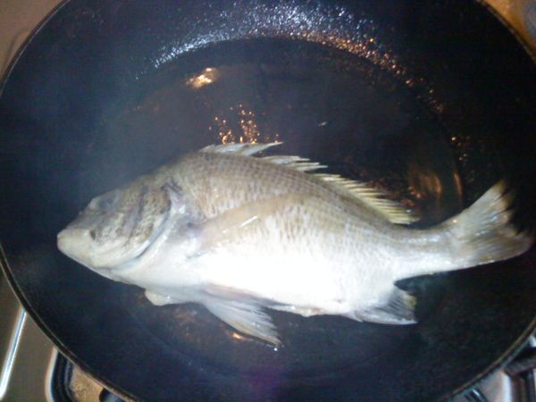 油熱後，徐緩放入鮮魚，輕輕晃動避免沾黏，中小火煎至表面金黃，翻面續煎