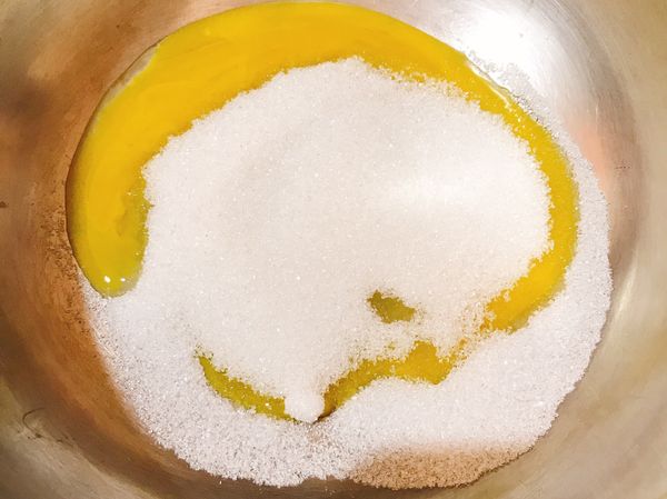 將蛋黃放入鍋盆中加入細砂糖用打蛋器攪拌至顏色變淺，接著加入過篩的低筋麵粉和玉米粉拌勻，接著加入香草精及微溫熱的牛奶（可用微波加熱）攪拌拌勻