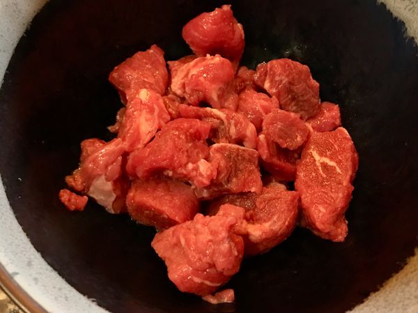 將牛肉切成一口塊狀，加入少許鹽巴抓醃，備用。