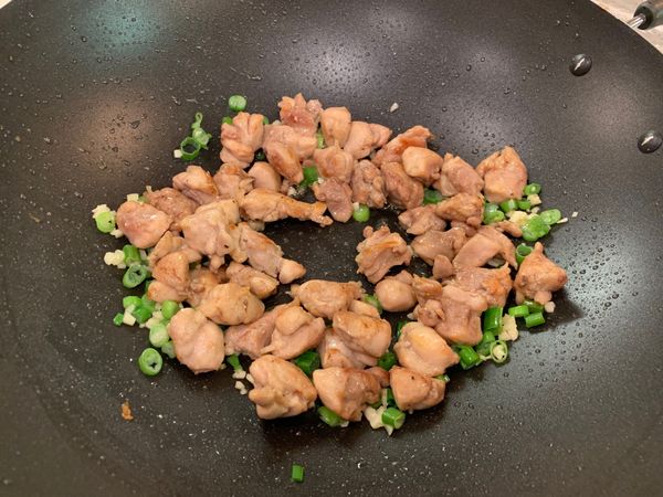將雞丁與一半的蔥綠下鍋，下少許鹽及胡椒翻炒，起鍋前再將剩下一半的蔥綠加入翻炒一下即可
