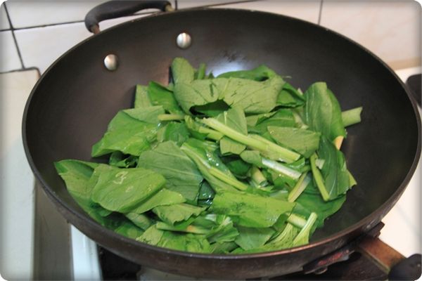 放入油菜以及少許的水，大火快炒