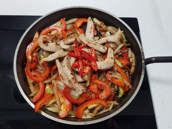 加入剛剛炒好備用的松阪豬肉條、辣椒，拌炒均勻後。