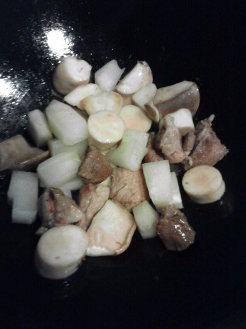 起油鍋爆香豬肉塊,再加入杏鮑菇和白蘿蔔一起炒香