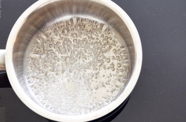 先來做焦糖，在一個深鍋裡倒入糖跟水，用中火煮到糖融化，一旦沸騰，水份完全蒸發，就絕對不能攪拌，此時要緊盯鍋子裡的變化