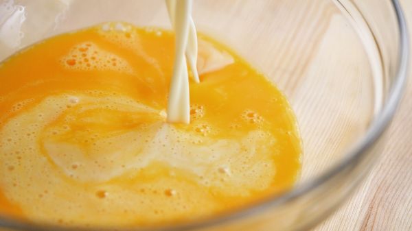 把一顆蛋加一顆蛋黃打散，將煉乳牛奶倒入打散的蛋液裡，繼續攪拌均勻