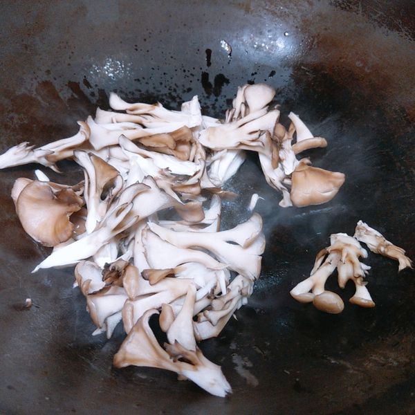 熱鍋，下少許沙拉油後加入舞菇，炒出舞菇的香氣。