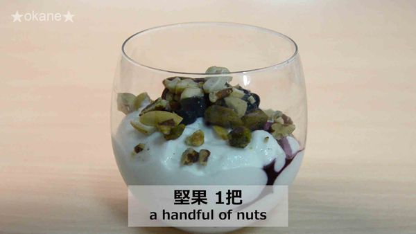 半杯無糖希臘優格襯底，加入適量藍莓及碎堅果。