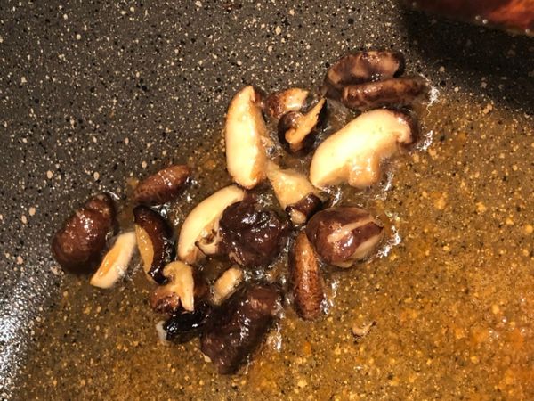 香菇泡水泡軟, 切條狀, 放入炒鍋小火炒香, 再放入切小塊的雞肉拌炒.