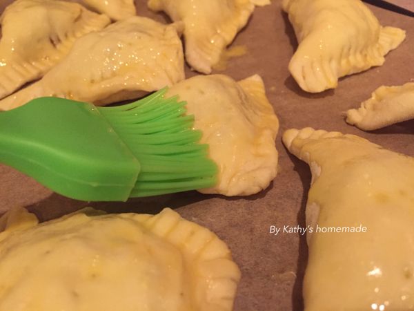 雞蛋打散、咖哩餃排放烤盤、表面用刷子刷上蛋液。