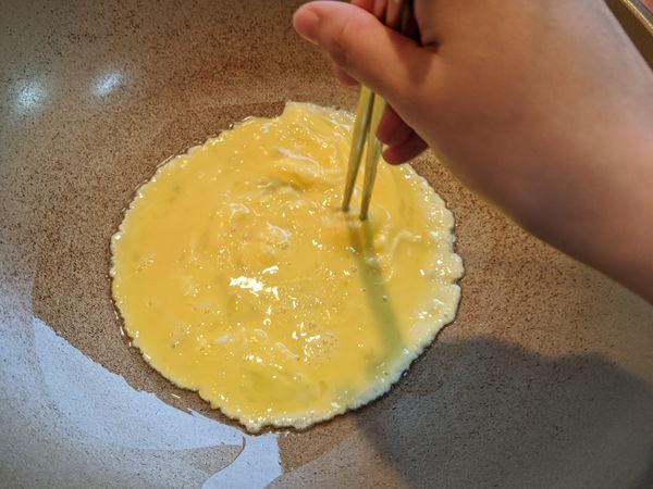 用筷子或鍋鏟，從中心用同心圓的方式在蛋液上由內而外重複畫圈。看到蛋液呈現六七分凝固就可以關火了。