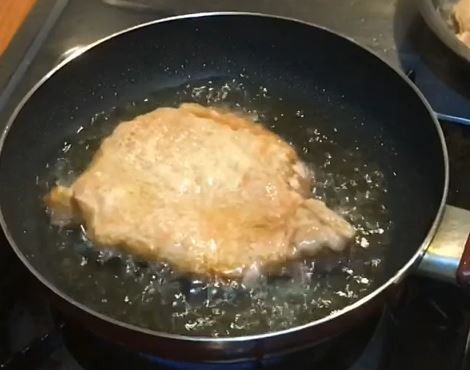 轉為中小火加熱一分半，待油爆轉大表示豬排加熱面已熟成