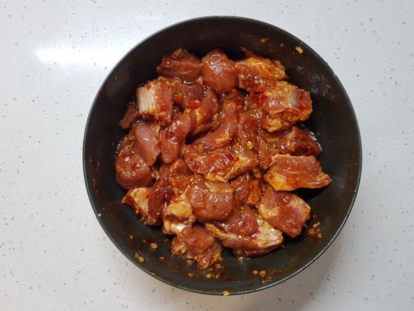 將醃肉料和豬小排抓勻，蓋上保鮮膜，放進冰箱醃製2小時。