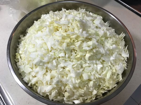 準備蔬菜餡部分，將高麗菜切碎後加入鹽巴，放置30分鐘至一小時出水，出水後以雙手稍微擠壓高麗菜瀝水。（圖為脫水前狀態）