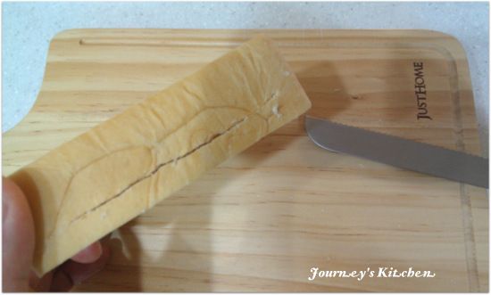 首先來處理較麻煩的步驟，將吐司從側面（左右兩旁不要切到，留約1cm的距離）三分之一或中間處，橫切一刀（盡量不插到底）。