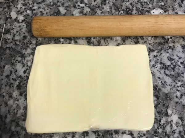 用包鮮膜將奶油包起來，用桿麵棍將奶油敲壓成約12x12公分大小；並放入冷藏；