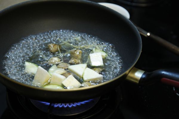 放入絲瓜、蛤蜊，待蛤蜊開口後入鹽調味即可。