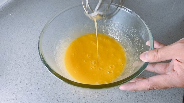 雞蛋和砂糖攪拌至變成淺黃色，加入牛奶。