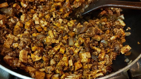 將肉末倒進醬鍋中拌炒，下醬油、米酒跟冰糖