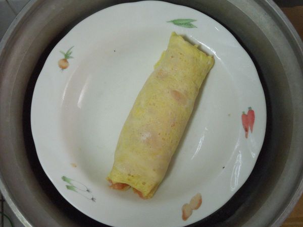 將慕絲捲放在平盤上，放進電鍋，外鍋加1杯水蒸熟。