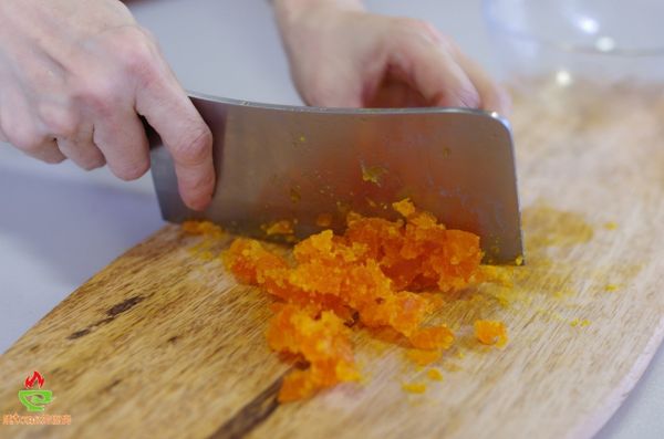 鹹蛋黃用1大匙的米酒浸泡約1個小時，鹹蛋黃變濕潤，用菜刀將蛋黃壓扁切碎。