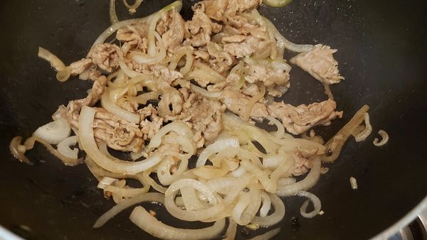 鍋中下點油，炒洋蔥絲跟豬肉絲，用米酒、烤肉醬跟黑胡椒粉調味，炒好先放一旁備用