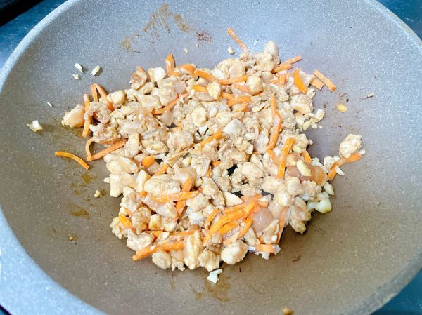 雞丁大約拌炒到半熟（雞丁顏色有一半變成白色）後就準備加入毛豆。