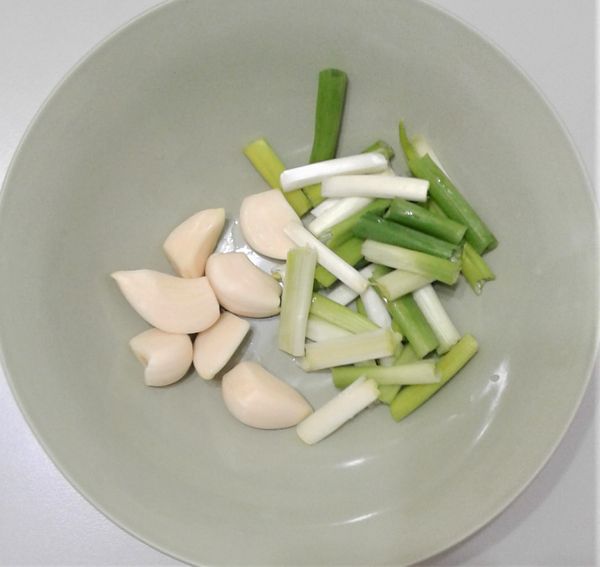 將蒜頭用水清洗乾淨，並去除瑕疵的部位；青蔥洗淨後，切成3公分的蔥段。