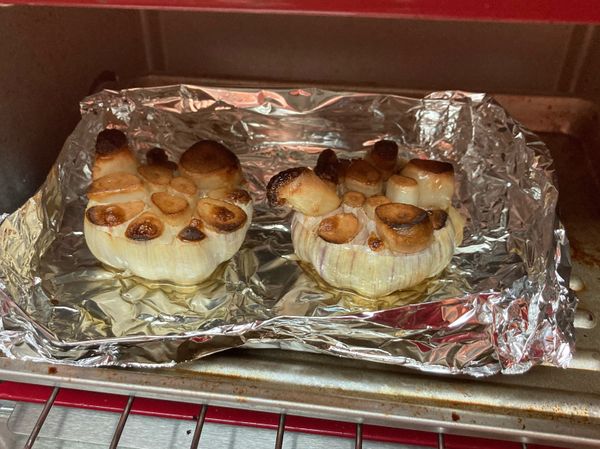 以下皆為自己參考原食譜後的製作記錄
1. 直接拿兩大顆大蒜簡略剝除多餘外皮
2. 整顆砍頭（別丟，可另作其他料理）
3. 用鋁箔紙折成容器（直接用烘焙皿應該也行），放入大蒜，每顆上頭再淋一大匙橄欖油
4. 用烤箱200°c烤30分鐘
烤的時候好香，好幾瓣大蒜自己往上擠出，好可愛