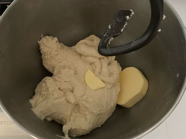 再放入奶油打至麵團出現薄膜，表面光滑即可