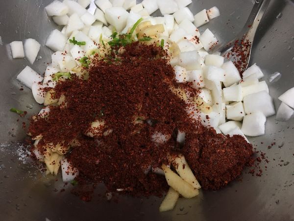 1小時後，將醃漬出來的水倒掉，將所有配料和調味料全部倒入白蘿蔔用湯匙攪拌均勻。