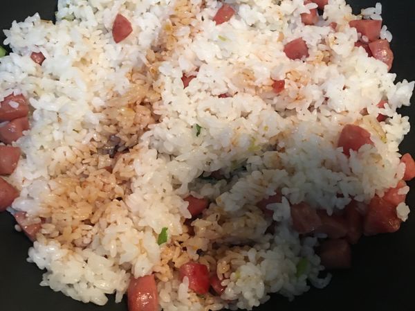 白飯炒鬆後，熗ㄧ大匙醬油，翻炒均勻。