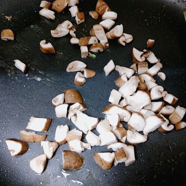 取一平底鍋熱鍋，用乾鍋先將鮮香菇丁炒出水份炒香。
