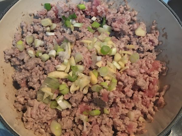 一點油起油鍋，先炒絞肉，肉大致都變色後，加入蒜末、蔥白炒香。