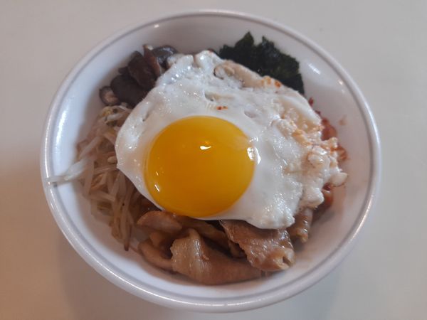 最後在中間鋪上太陽蛋，拌勻後即可享用。